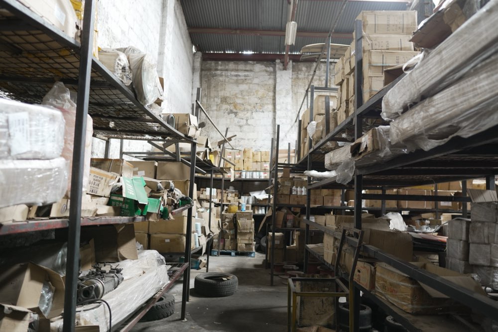 Racking aisles of boxed spare parts at Ajale Enterprises in Nairobi